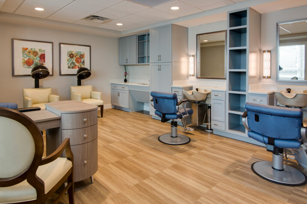 A beauty salon with chairs for haircuts and blow-outs at Heritage Oaks of Englewood, a senior living community near North Port, FL.